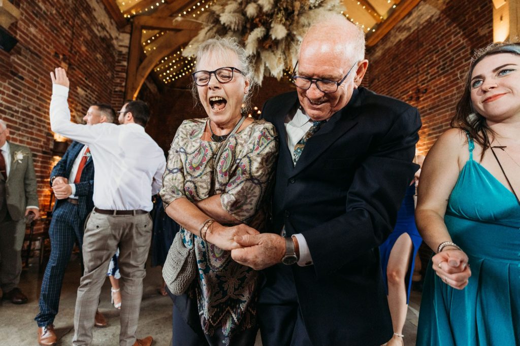 older wedding guests laughing on the dancefloor at hazel Gap