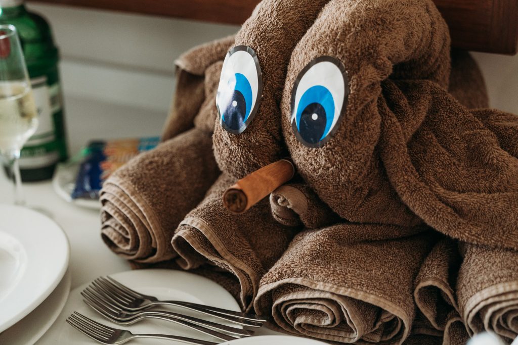 A towel in the shape of an Octopus, with a cigar in the mouth