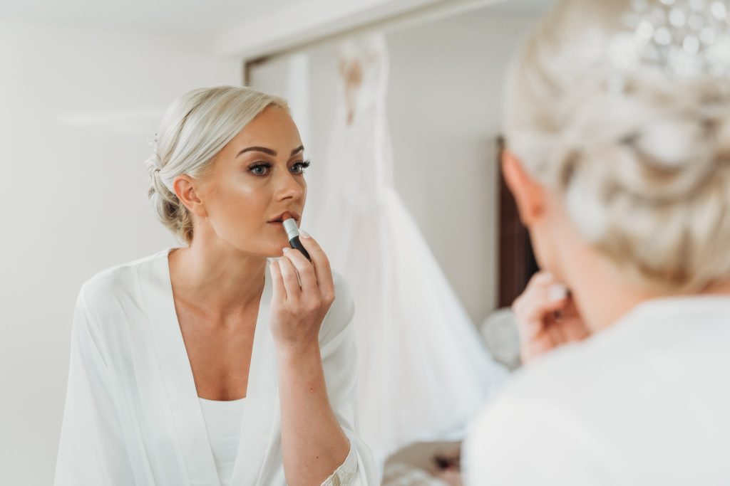 Bride applying finishing touches to her make up before her wedding at the Royalton Riviera