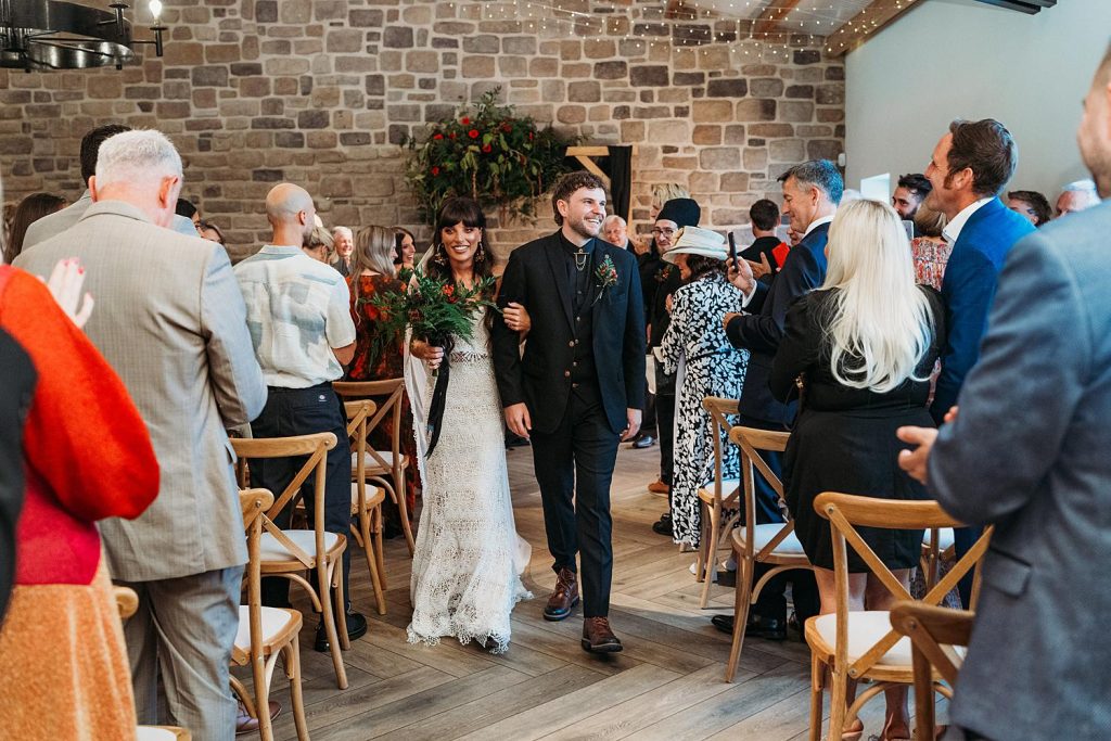 Bride walks down the aisle at Stretton Manor Barn