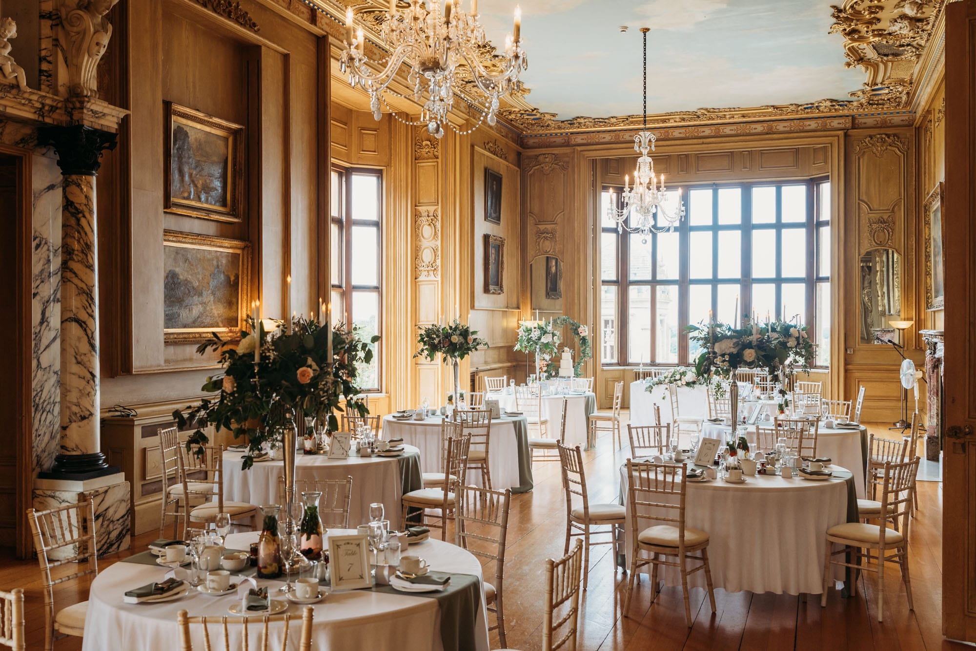 A photo from the back of the Long gallery with room decorated for a wedding breakfast at Harlaxton Manor