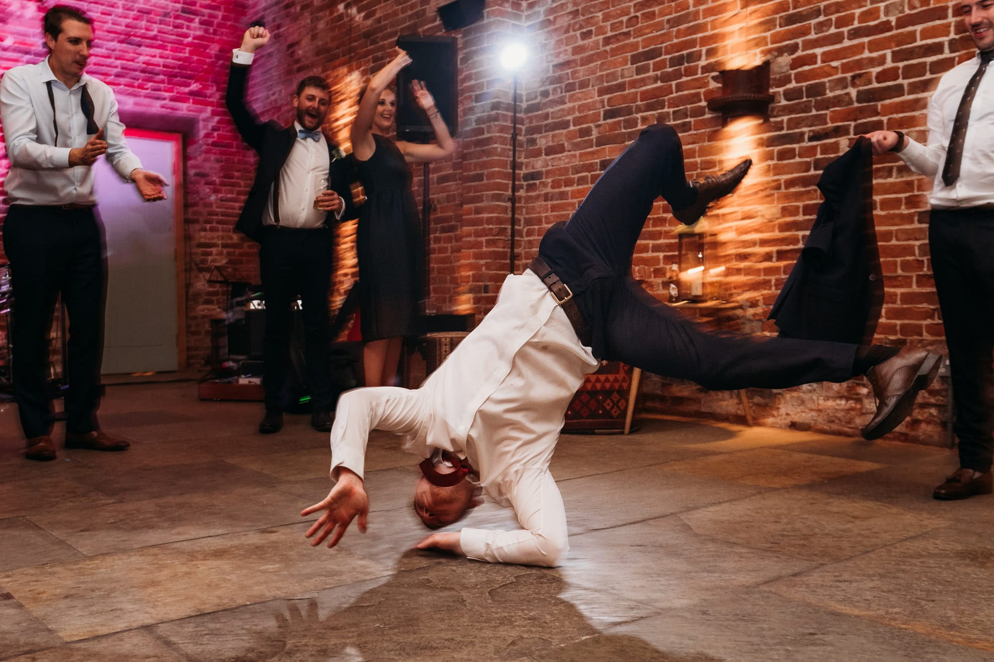 wedding guest breakdancing on the dancefloor