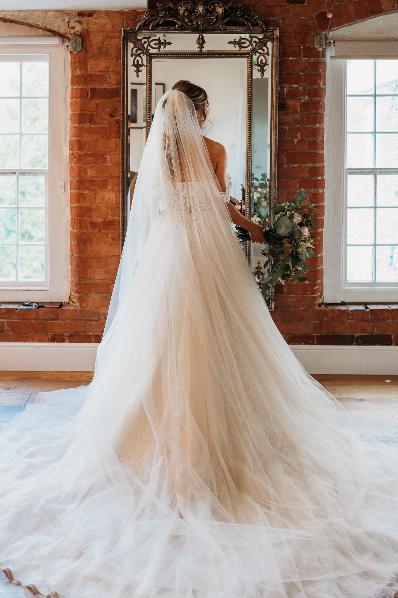 Back of bride's dress as she's standing in the getting ready room at West Mill