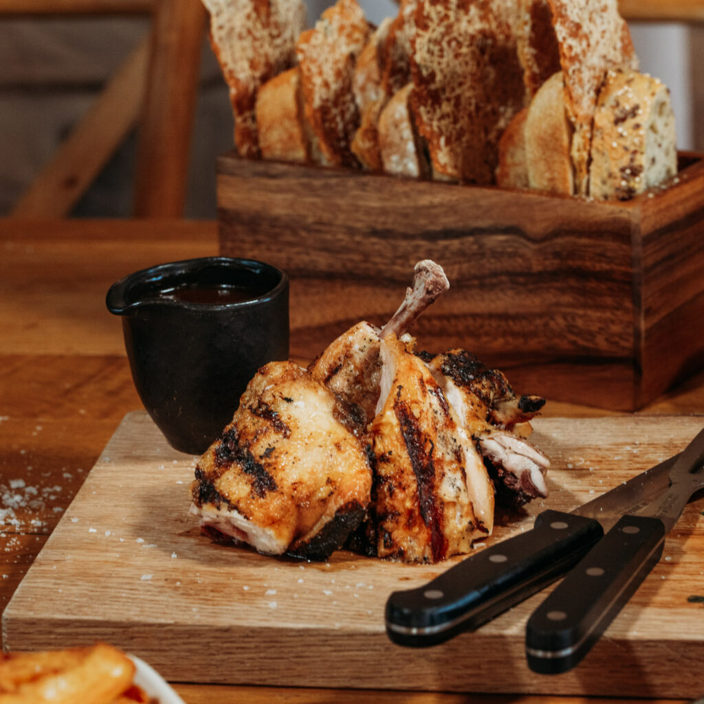 A wooden board with chicken